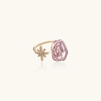 Adjustable ring with lavender baroque pearl and crystal star charm on gold-plated band against cream background.