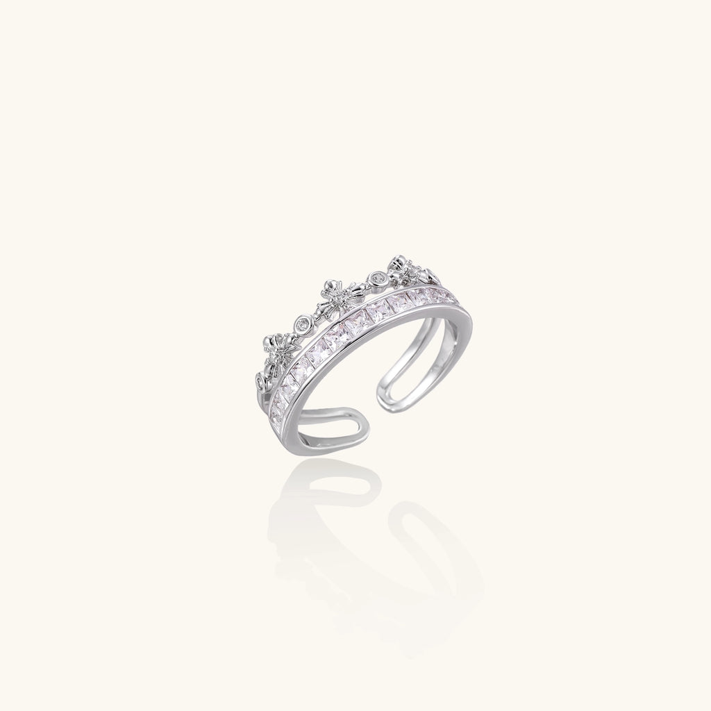 Adjustable gold-plated crown ring with zirconia crystals in ornate tiara design on white background.