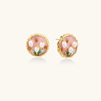 Round stud earrings with pink enamel background, white pearl tulips, green leaves, and twisted gold border on white background.