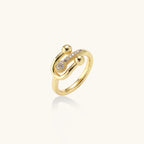 Modern gold-plated adjustable ring with safety pin design and sparkling cubic zirconia accents on white background