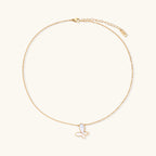 Delicate gold butterfly necklace with white mother of pearl wings on fine chain, displayed on neutral background.