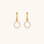 Gold-plated hoop earrings with circular cubic zirconia charm dangles displayed on neutral background.